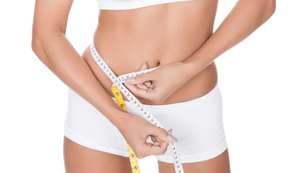 Woman in white underwear measuring her waist.